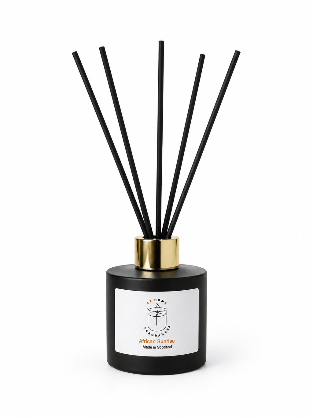 A reed diffuser bottle with a matte black cylindrical base, a gold collar, and six black reeds, featuring a white label with the scent name 'African Sunrise' and 'Made in Scotland' printed in orange.