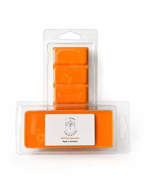Two packs of bright orange wax melts in clear plastic clamshell packaging on a white background. The front pack has a white label reading 'African Sunrise' and 'Made in Scotland' 