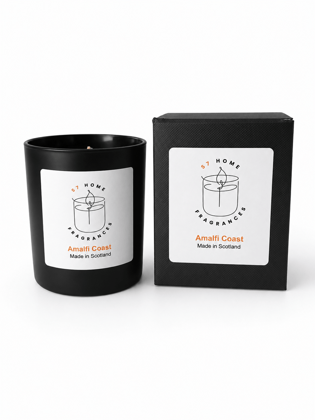 A black scented candle in a matte black glass vessel with a white label, shown next to its black packaging box. The label reads 'S7 HOME FRAGRANCE' and 'Amalfi Coast Made in Scotland'.
