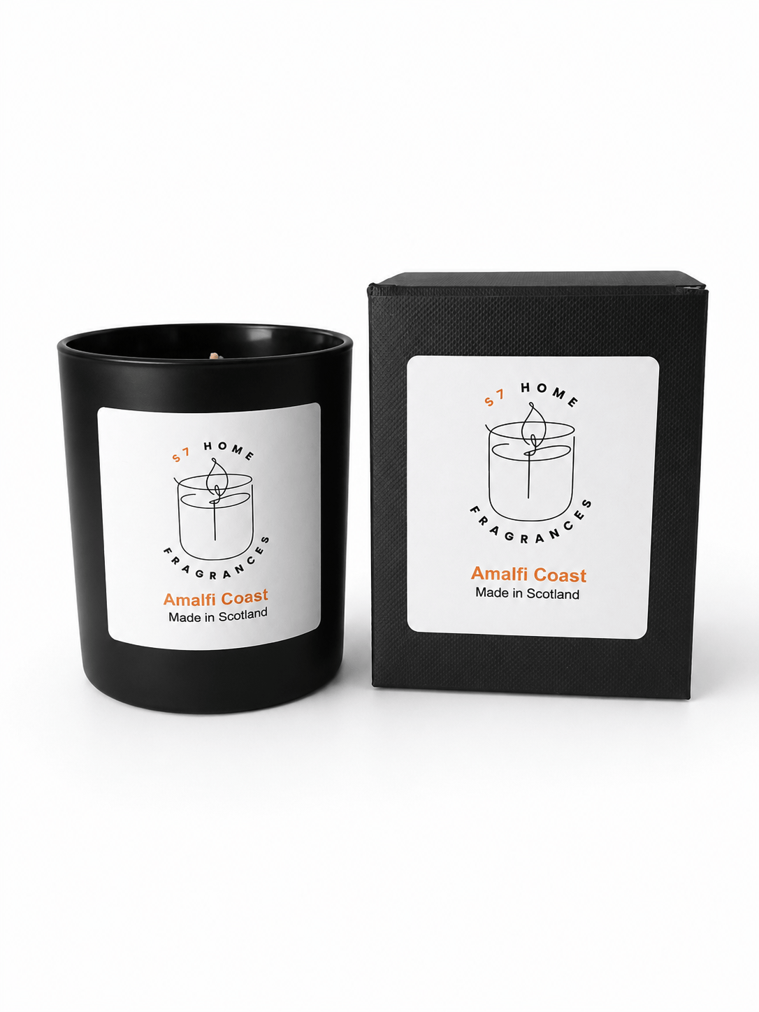 A black scented candle in a matte black glass vessel with a white label, shown next to its black packaging box. The label reads 'S7 HOME FRAGRANCE' and 'Amalfi Coast Made in Scotland'.
