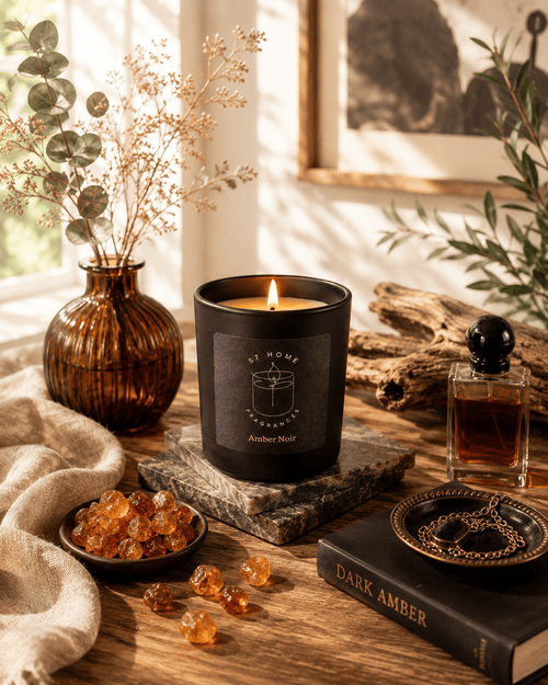 A black scented candle labeled 'S7 Home Fragrances' and 'Amber Noir' sits lit