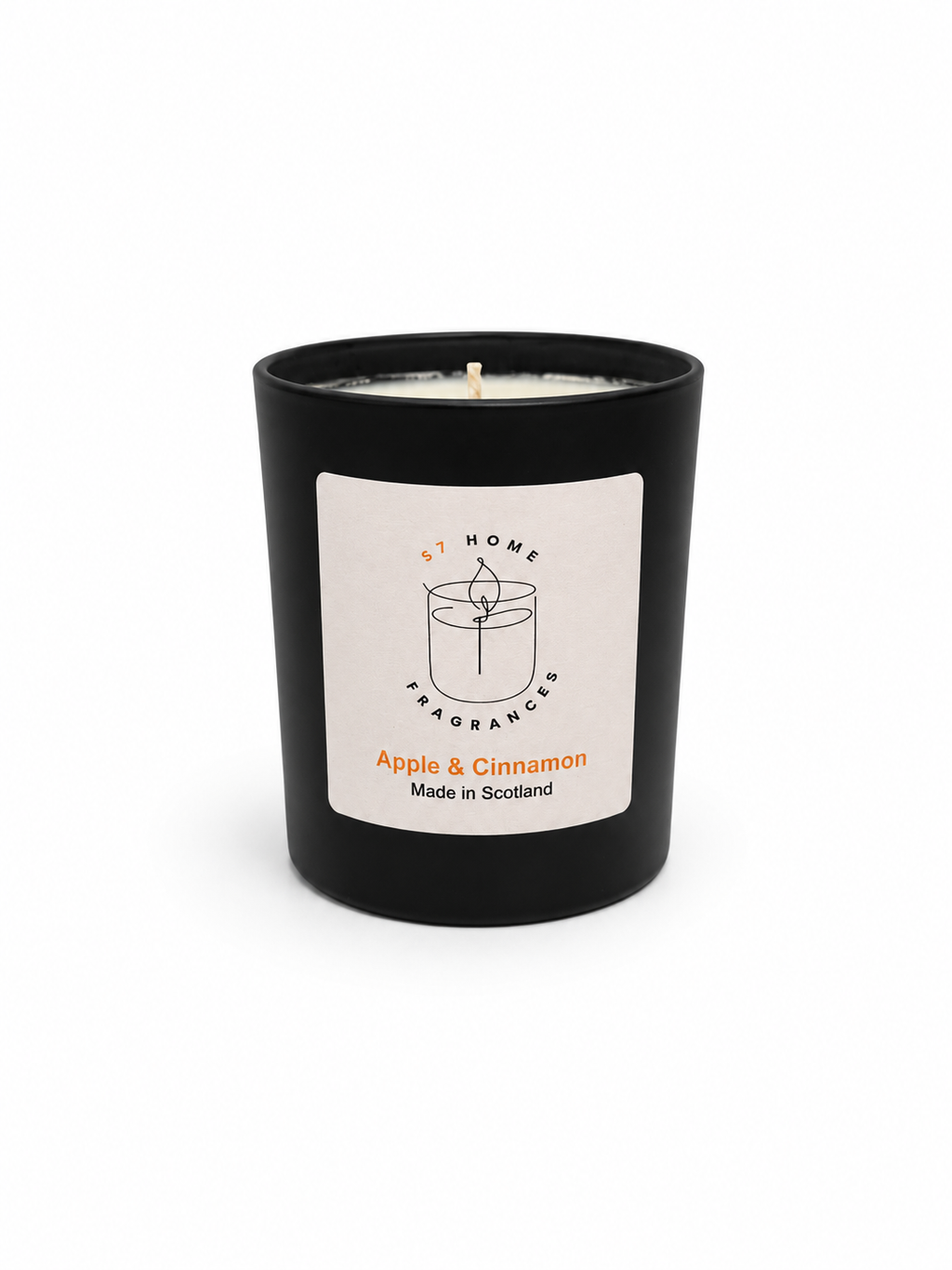 Apple & Cinnamon candle in a black jar with a white label on a white background