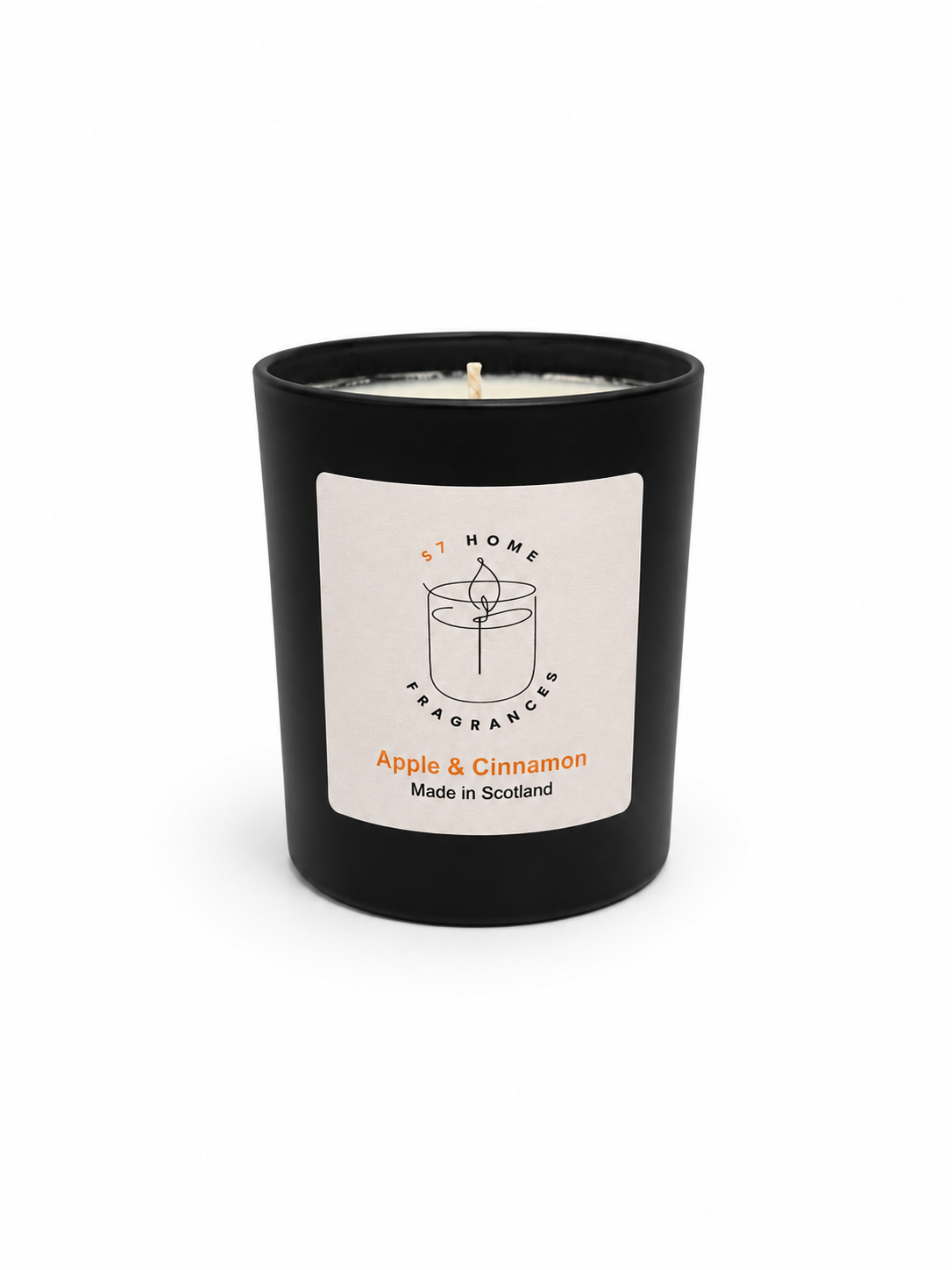 Apple & Cinnamon candle in a black jar with a white label on a white background