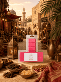 A packaged set of bright pink wax melts displayed in clear plastic packaging on a stone surface, with an ornate Arabian-themed market scene in the background. The front package has a white label reading 'Arabian Souk'.