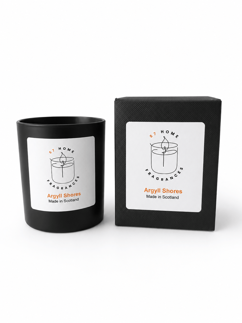 A black glass candle jar with a white label next to its matching black box packaging, both featuring the 'Argyll Shores' scent name and a simple candle line drawing.
