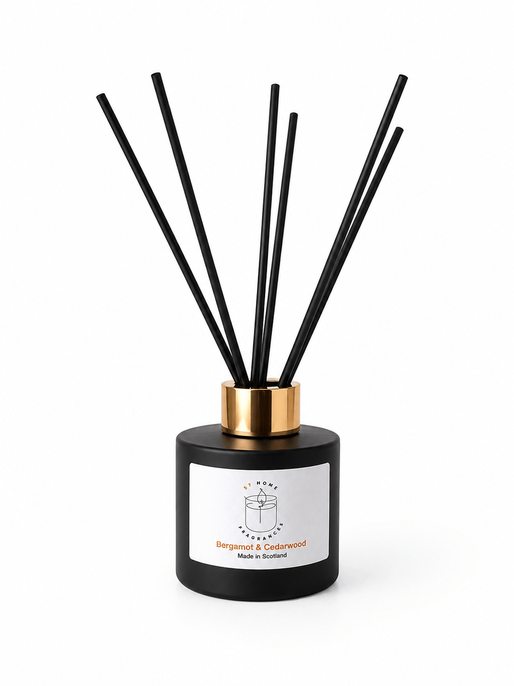 A reed diffuser bottle with a matte black cylindrical body, a gold collar, and multiple black reeds, shown on a clean white background. The front label reads Bergamot & Sandalwood.