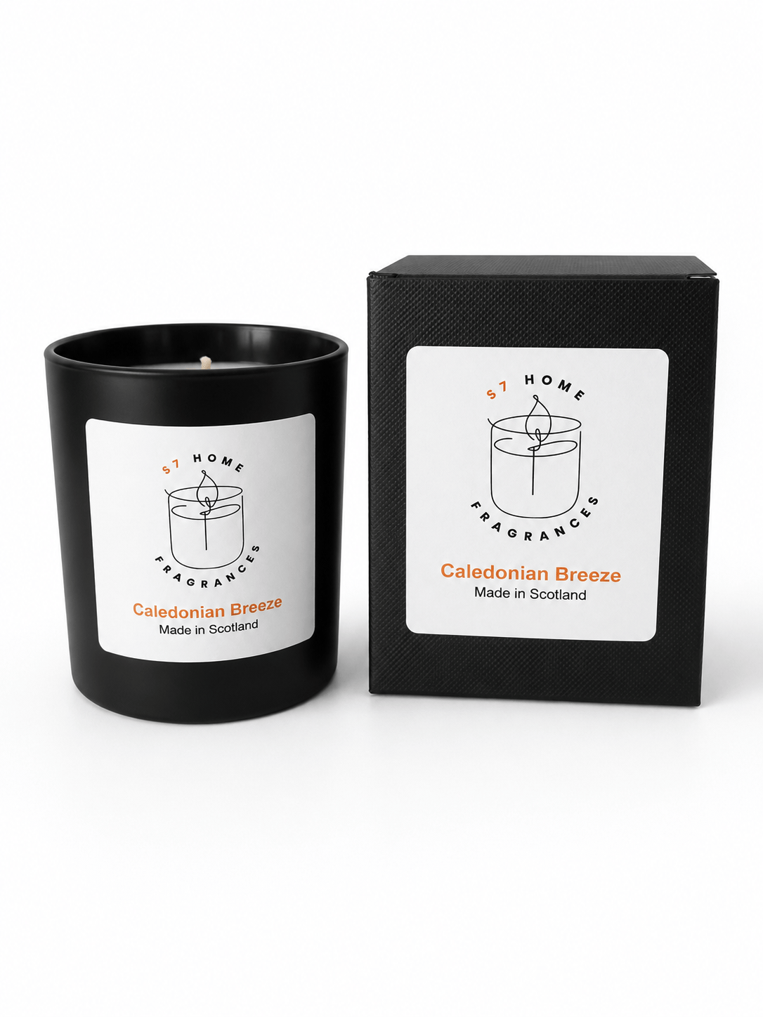 A black candle jar with a white label next to its matching black box packaging, both featuring the brand 'S7 HOME Fragrances' and the scent name 'Caledonian Breeze'.