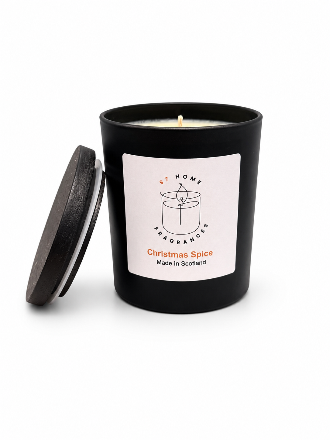 Christmas Spice candle in a black jar with a white label and a black wooden jar topper on a white background