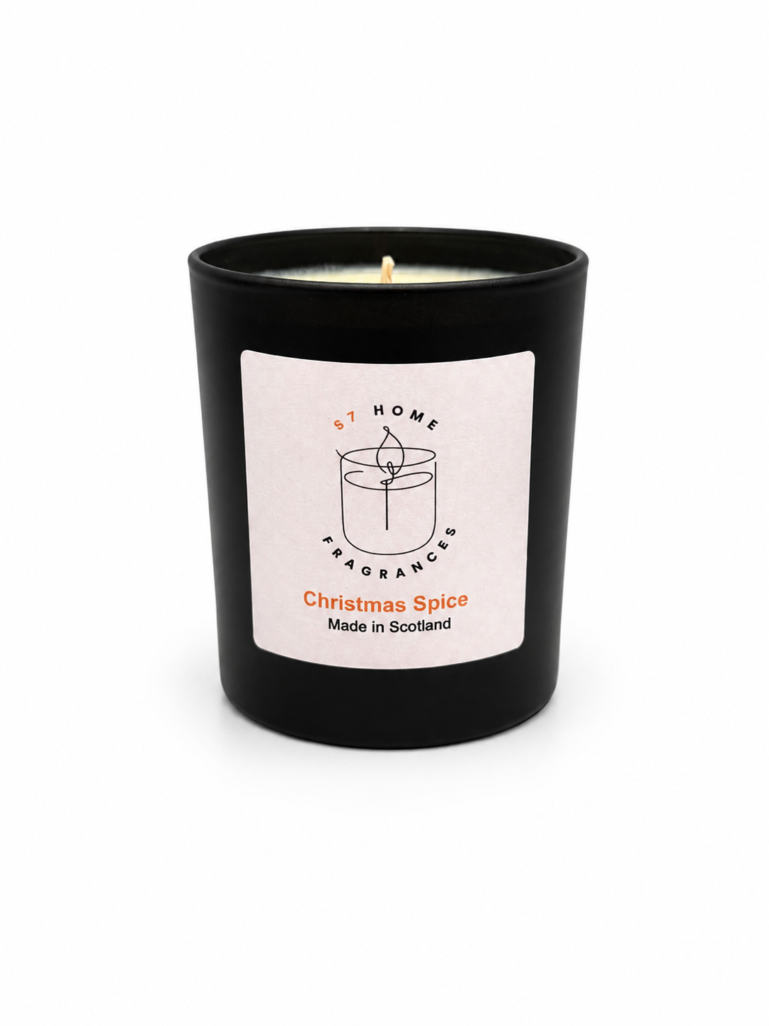 Christmas Spice candle in a black jar with a white label on a white background