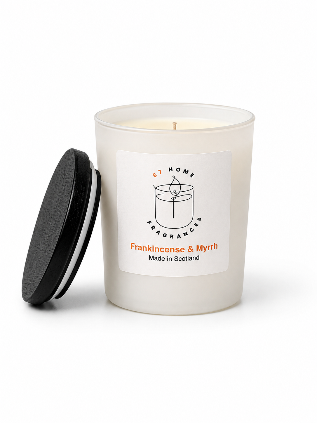 Frankincense & Myrrh candle in a white glass jar with a black wooden jar topper on a white background, featuring a label with branding and product details.