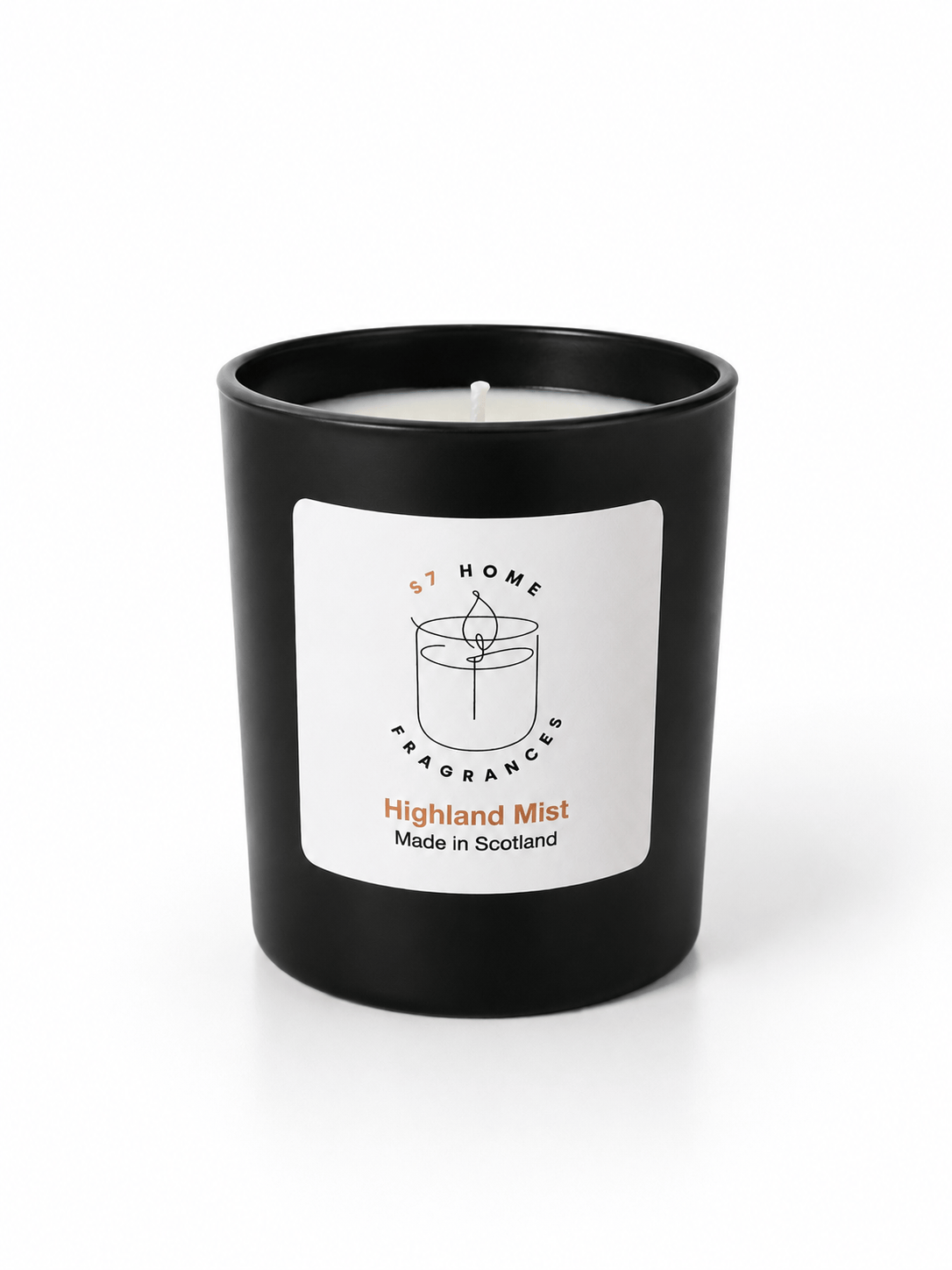 A black glass jar candle with a white label reading 'S7 HOME Fragrance' and 'Highland Mist Made in Scotland' on a clean white background.