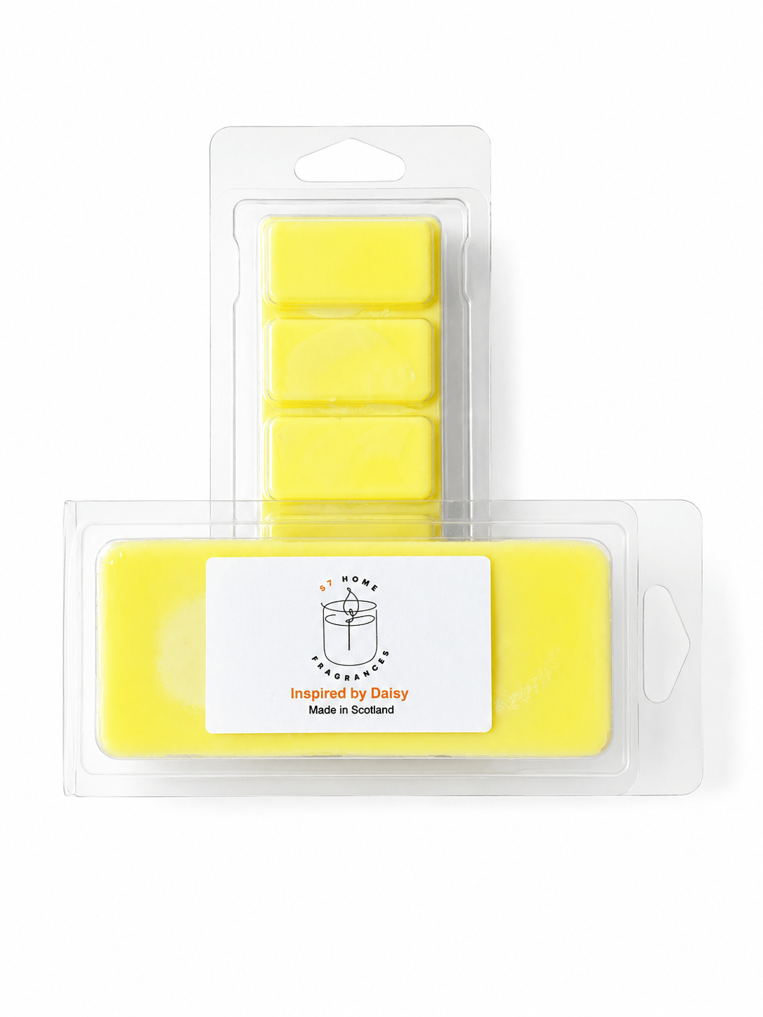 Yellow wax melts in clear plastic packaging, featuring a larger rectangular bar in the front with a white label reading 'Inspired by Daisy' and 'Made in Scotland' and five smaller rectangular bars behind it.