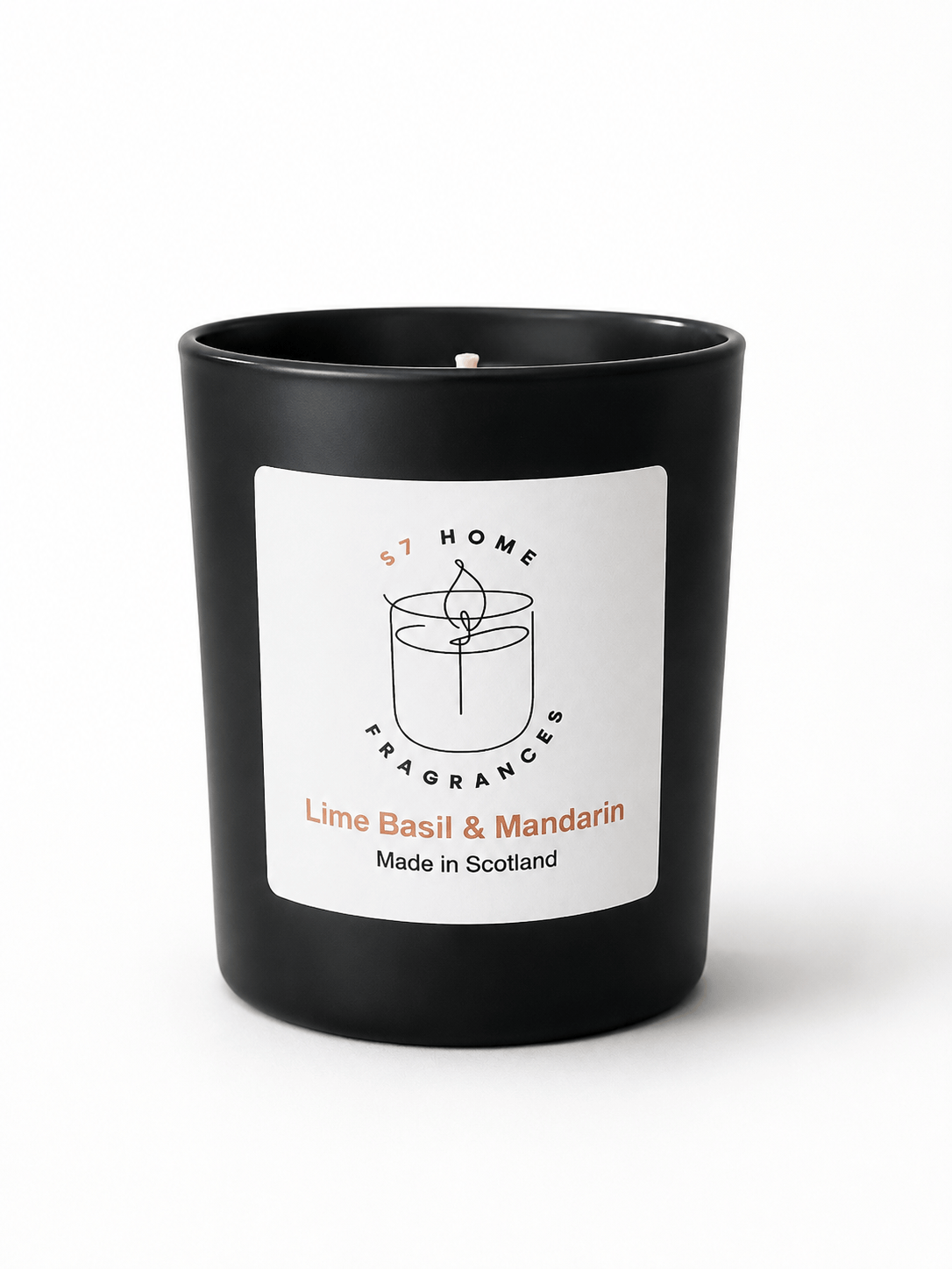 A matte black candle jar with a white front label reading 'S7 HOME FRAGRANCES' and 'Lime Basil & Mandarin Made in Scotland'.