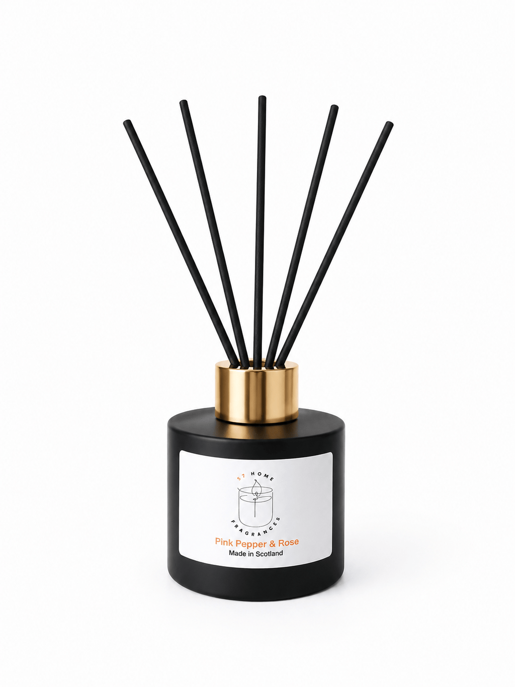 A reed diffuser bottle with a matte black cylindrical base, a metallic gold collar, and six black reeds extending upward. A white label on the front reads 'S7 Home Fragrance' and 'Pink Pepper & Rose'.