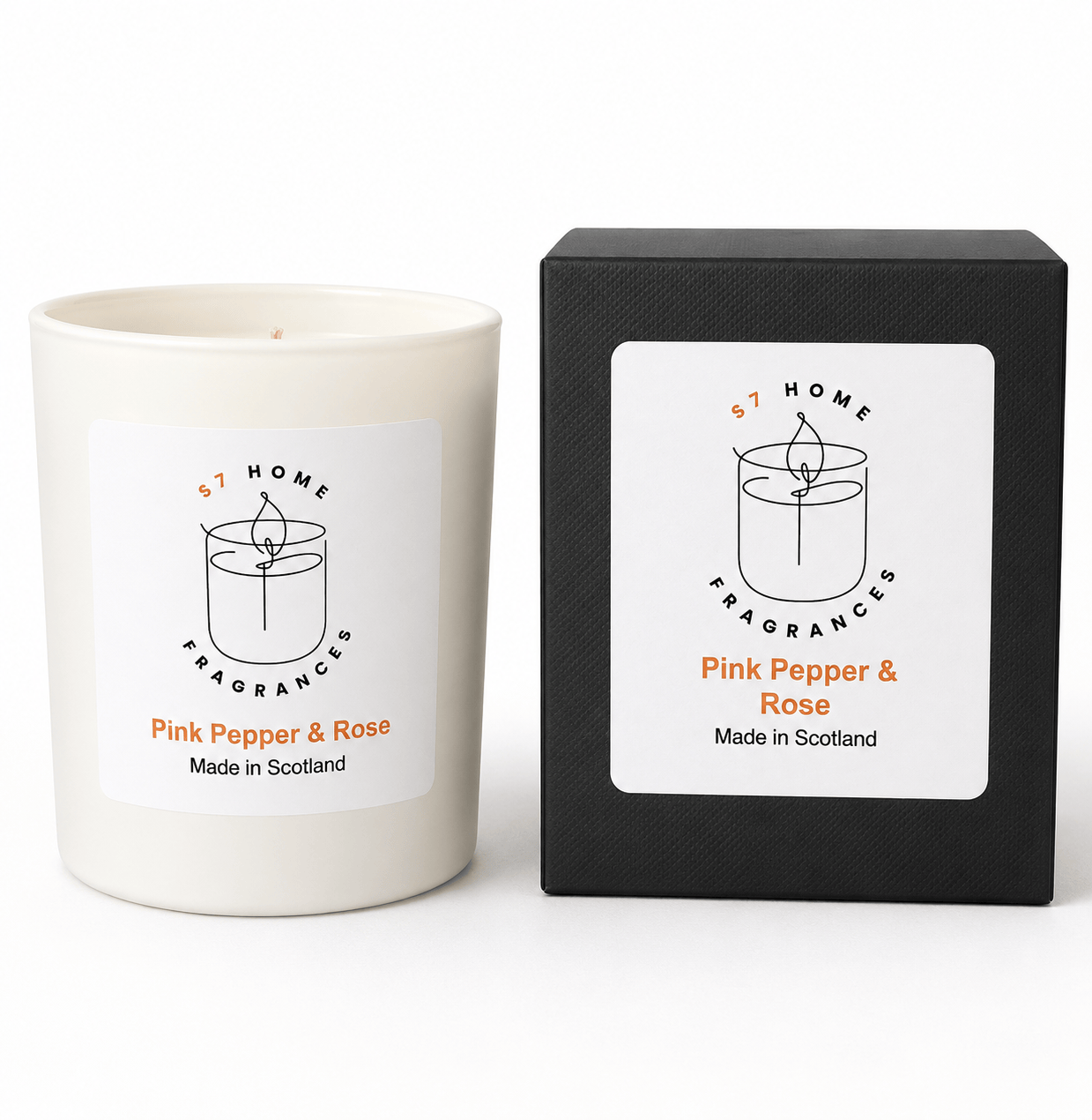 A white candle jar labeled 'S7 Home Fragrances Pink Pepper & Rose' stands next to its black textured packaging box on a clean white background.