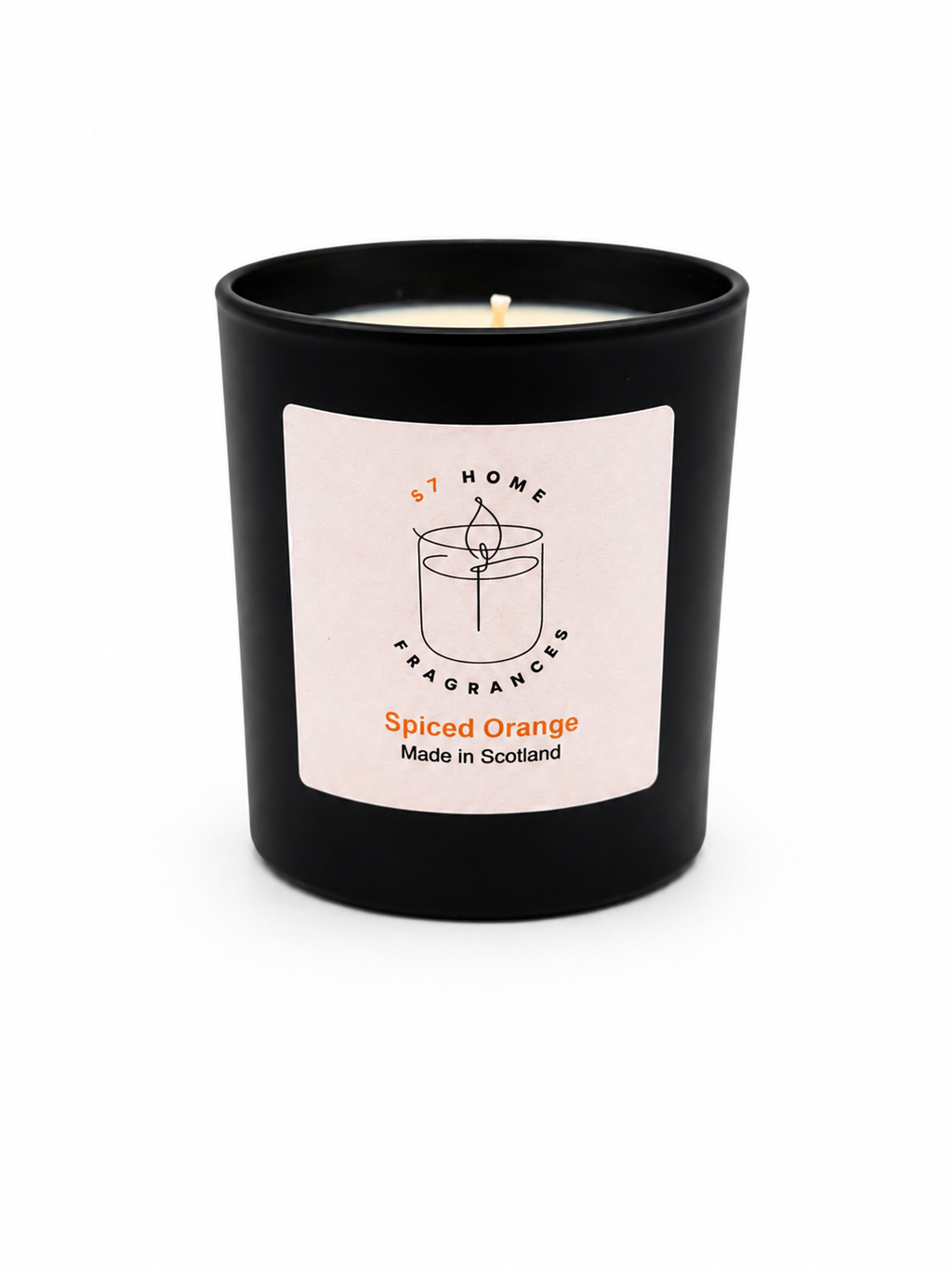 Spiced Orange candle in black jar with a white label on a white background